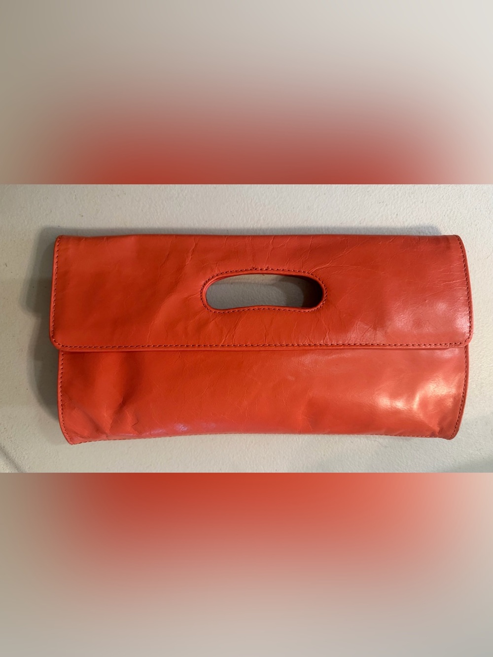 HOBO Coral Orange Leather Clutch with Cutout Handle